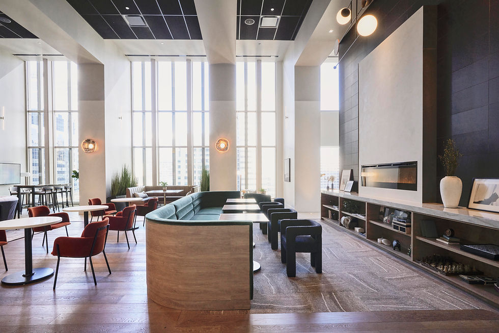 Modern office lounge area with a built-in booth, tables, and chairs, designed to foster collaboration and relaxation. Office design by Henricksen.