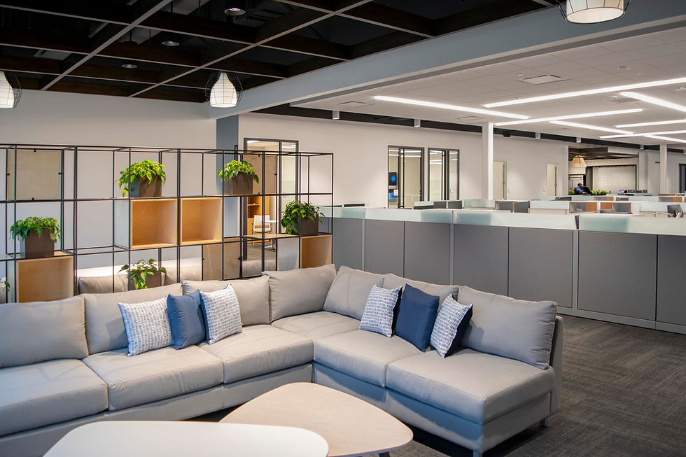 Flexible office layout offering a mix of collaborative lounge seating and individual workspaces. Office furniture solutions by Henricksen.