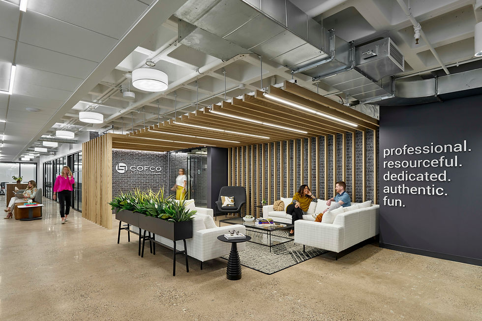 Contemporary office waiting area with modern sofas, armchairs, and a unique green wall feature. Office furniture solutions by Henricksen.