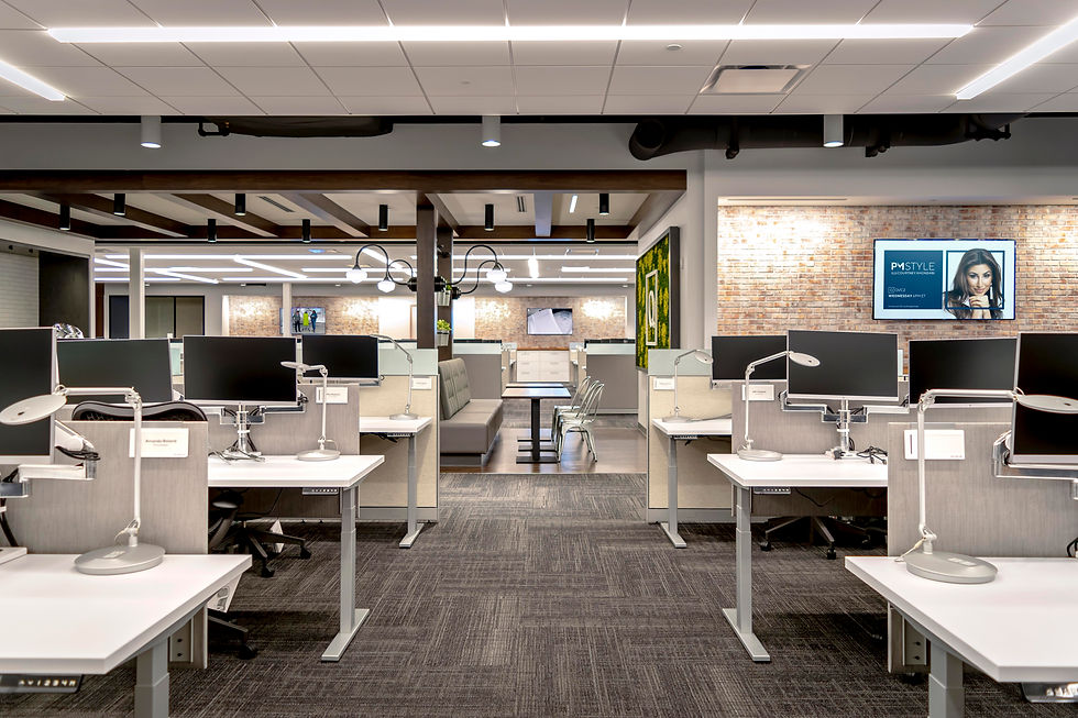 Modern and functional office space with open workstations and a comfortable lounge area. Office design by Henricksen.