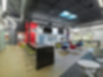 Modern office break room or kitchen area with a large island, comfortable seating, and a contemporary design. Office design by Henricksen.