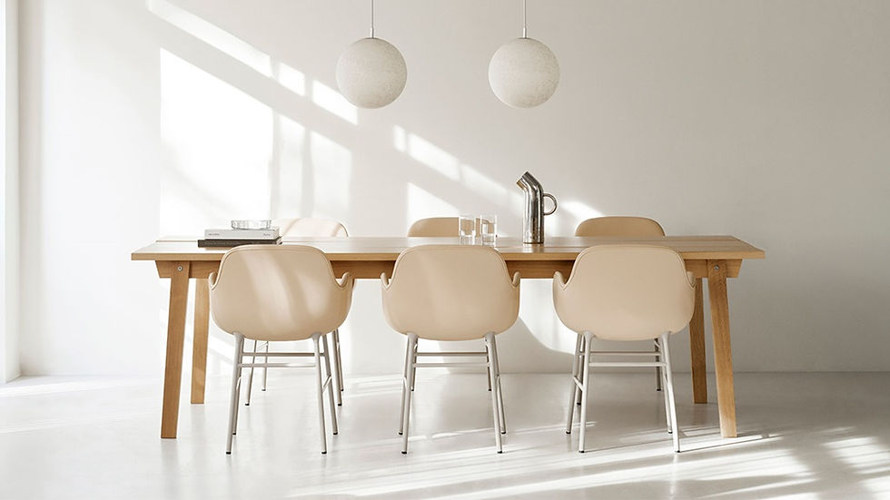 Modern dining or meeting area with a simple wooden table and comfortable chairs. Office design by Henricksen.