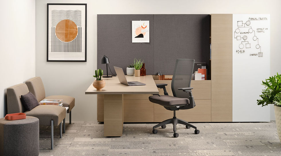 Modern office workspace featuring a sit-to-stand desk, ergonomic chair, and storage solutions from Henricksen.