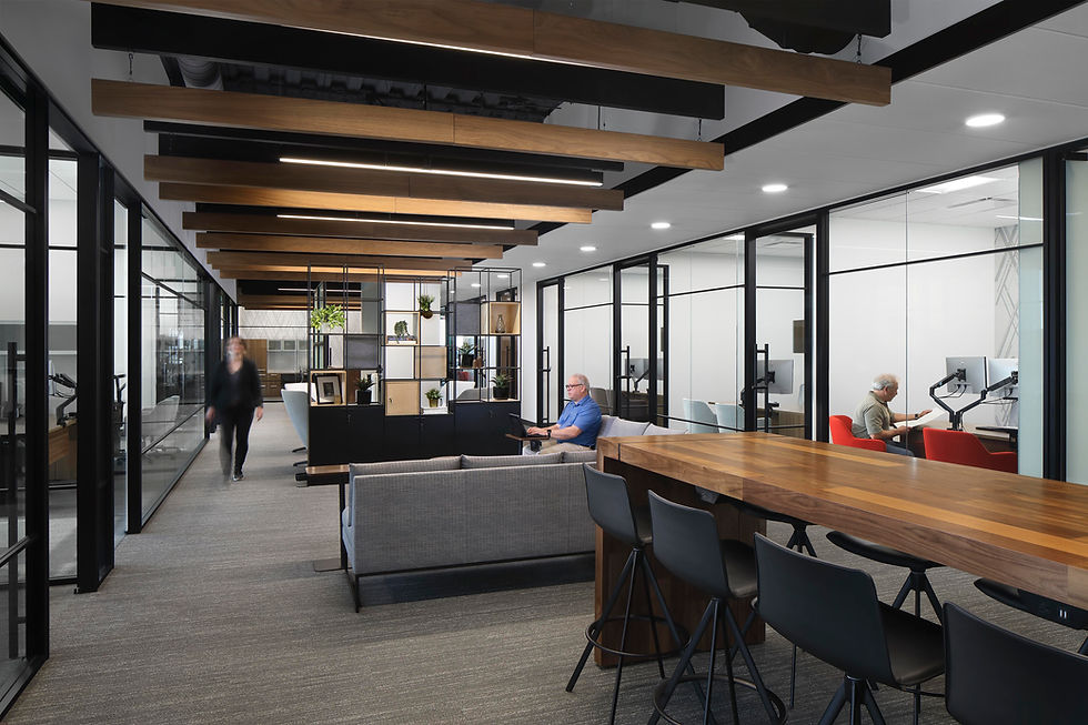 Modern and open office space with glass-walled offices, collaborative workspaces, and contemporary furniture.
