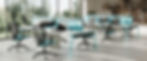 Modern open-plan office with workstations featuring ergonomic chairs and privacy screens. Office design by Henricksen.