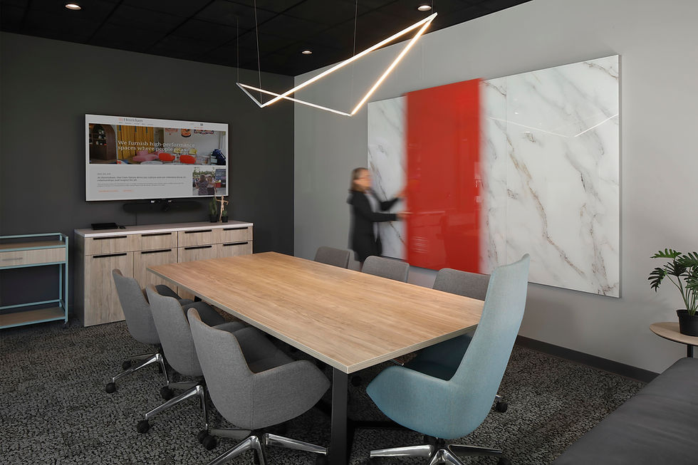 Modern meeting room with a large conference table, comfortable chairs, and a contemporary design. Office design by Henricksen.